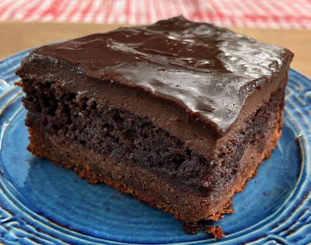 Chocolate Cake Slice On Pink Plate With Glossy Ganache